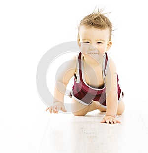 Baby happy smiling with uncombed hairs, active tousled boy in sp