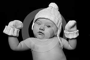 Baby in Hat and Mittens on Black