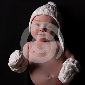 Baby in Hat and Mittens on Black