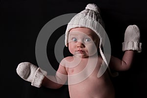 Baby in Hat and Mittens on Black