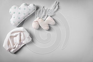 Baby hat and toys on white background, flat lay