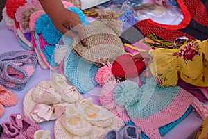 Baby hats and slippers knitted with worsted yarn. photo