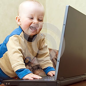 Baby having fun with laptop