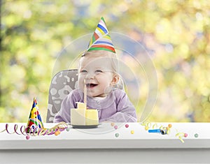 Baby having her first birthday, blurred background