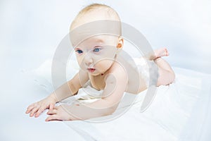 a baby with a hemangioma on his neck lies on a white background