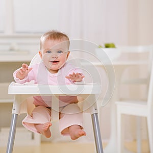 Baby in highchair waiting to be fed