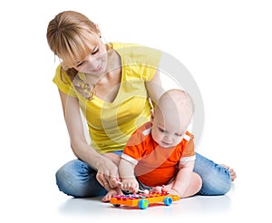 Baby and his mom play musical toys