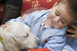 A baby with his white pet.