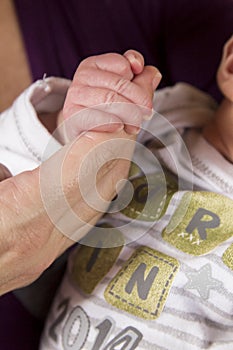Baby holding fingers newborn