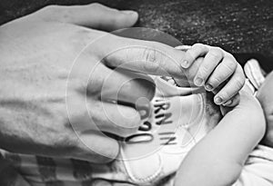 Baby holding his father`s finger