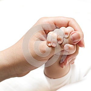 Baby holding mother hand