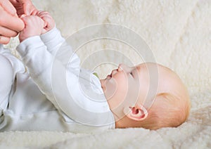 Baby holding mothers hands