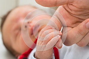 Baby holding parent finger