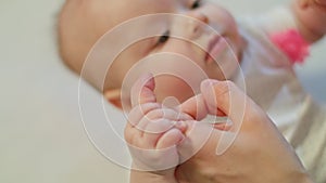 Baby holds her Mother`s Hands and try to sit down