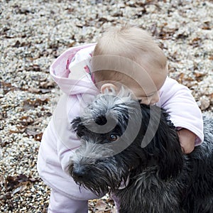 Baby hugging dog.