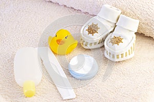 baby hygiene and bath items, shampoo bottle, baby soap, towel, yellow duck rubber toy,