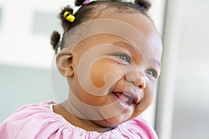 Baby indoors laughing