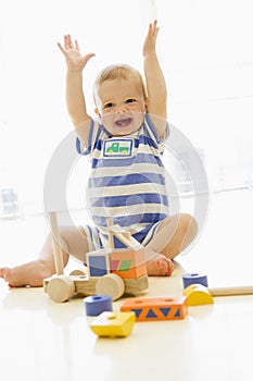 Baby indoors playing with truck