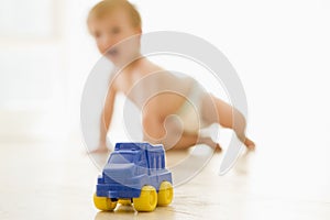 Baby indoors with toy truck