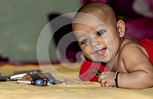 Baby infant cute holding lipstick with blurred background