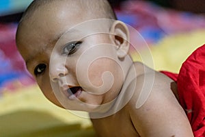 Baby infant cute innocent facial expression with blurred background