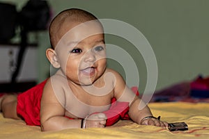 Baby infant cute innocent smiling facial expression with blurred background