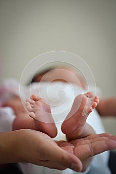 Baby Infant's Precious Feet Over Mother's Hand - Innocence Conce