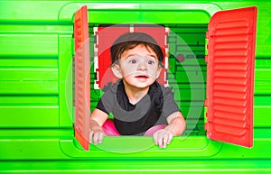 Baby inside toy house playhouse child look out the window