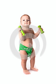 Baby kid, toddler in green diapers doing exercises with dumbbel