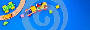 Baby kid toy background. Wooden toy train with colorful blocks on blue background