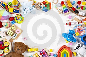 Baby kids toys frame. Set of colorful educational wooden, plastic and fluffy toys on white background. Top view, flat