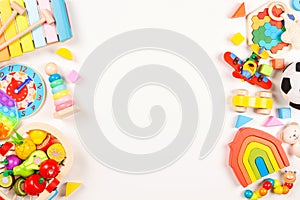 Baby kids toys frame on white background. Many colorful educational wooden, plastic toys. Top view, flat lay