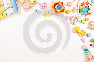 Baby kids toys frame on white background. Many colorful Montessori educational wooden toys. Top view, flat lay, copy