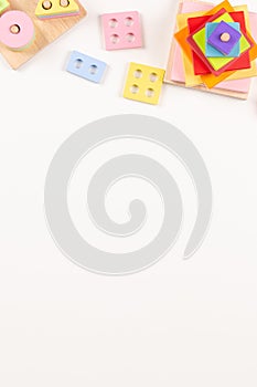 Baby kids toys frame on white background. Many colorful Montessori educational wooden toys. Top view, flat lay, copy