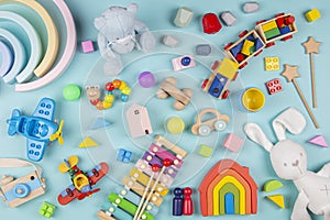 Baby kids toys pattern. Set of colorful educational wooden and fluffy toys on blue background. Top view, flat lay