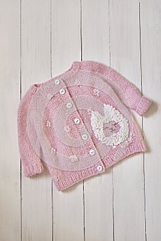 Baby knitted clothes. Handmade knitted clothes with embroidery