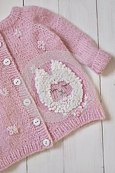 Baby knitted clothes. Handmade knitted clothes with embroidery