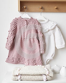 Baby knitted clothes. Handmade knitted clothes with embroidery