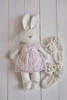 Baby knitted clothes and toys. Handmade knitted clothes with embroidery