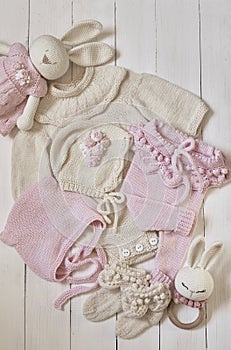 Baby knitted clothes and toys. Handmade knitted clothes with embroidery