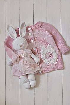 Baby knitted clothes and toys. Handmade knitted clothes with embroidery