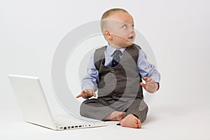 Baby with Laptop Looks into Copy Space