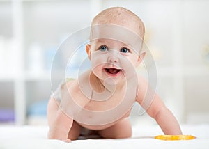 Baby laughing, creeping and playing in nursery photo