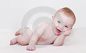 Baby Laying Down and Laughing photo