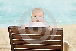 Baby Leaning On Deckchair On Beach