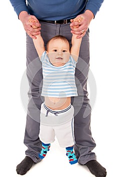 The baby learns to do the first steps