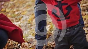 The baby learns to walk. Mom and Dad help his son to take the first steps