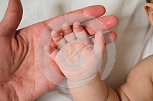 Baby lies in a white bed