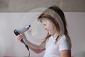 Baby little Girl dries hair,taking care of yourself, th