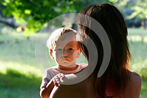 Baby looking over mother's shoulder